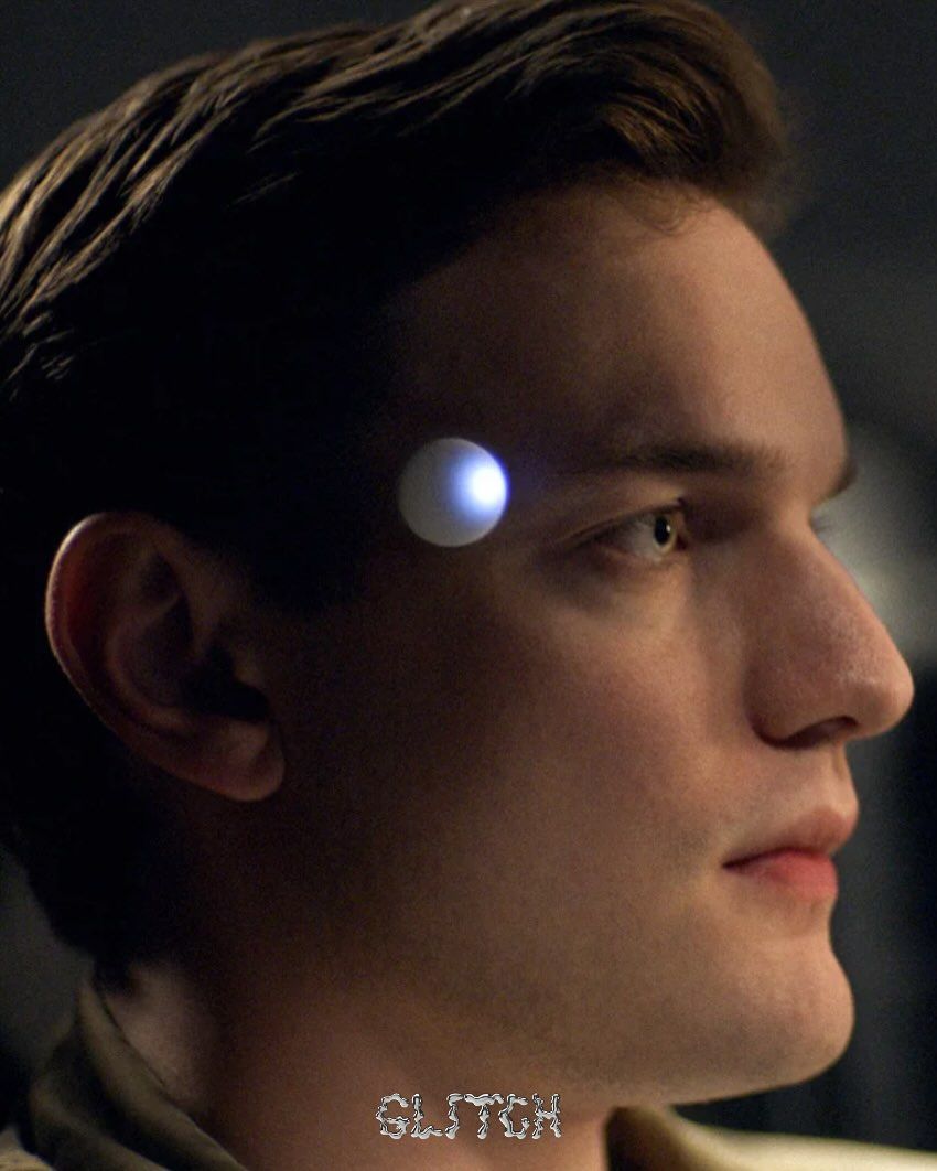 Close-up of a person with a glowing blue orb on their forehead, labeled 'SLITCH'.